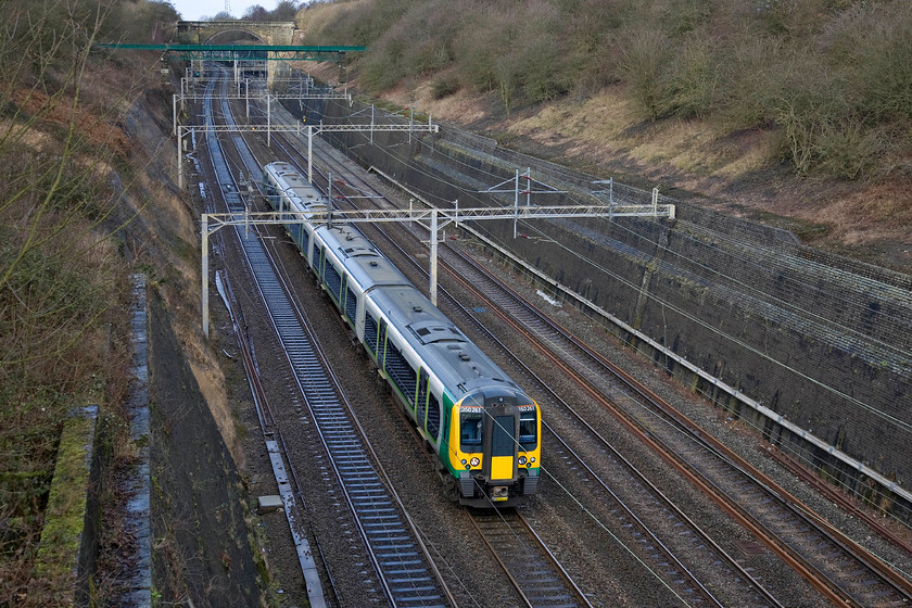 350261, LM 11.02 Crewe-London Euston, Roade cutting 
 350261 takes the fast line through Rode cutting forming the 11.02 Crewe to Euston service. Whilst the sun is not fully out at least there is some good light deep down in the cutting something that is at a premium during the winter months. 
 Keywords: 350261 LM 11.02 Crewe-London Euston Roade cutting London Midland Desiro