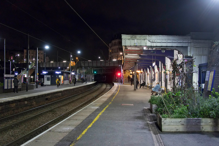 Kentish Town station 
 A comparison with my 1979 image taken from about the same spot reveals very many similarities at Kentish Town station, see..... https://www.ontheupfast.com/v/photos/21936chg/27444293604/kentish-town-station The delightful wooden canopy on the down slow platforms with its alcove style seating bays has been demolished making way for a far more barren and exposed platform. However, the up slow still remains very similar but for it being modernised. The buildings surrounding the station at road level are virtually identical with little having changed during the intervening forty years. 
 Keywords: Kentish Town station