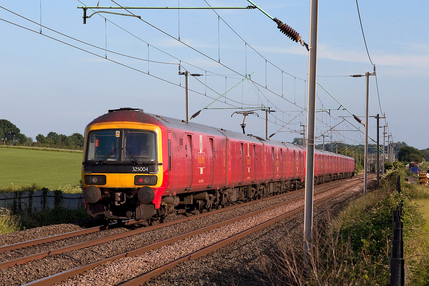 325004, 17.00 Warrington Royal Mail-Willesden (1A91), Milton Malsor 
 Having been well and truly bowled by a class 350 unit, a going away shot will have to suffice! The Royal Mail livery of these class 325 units makes for a really refreshing change from the usual paint schemes and it really stands out in its environment as here at Milton Malsor near to Northampton. 325004 brings up the rear of the 17.00 Warrington to Willesden Royal Mail working. 
 Keywords: 325004 17.00 Warrington Royal Mail-Willesden 1A91 Milton Malsor