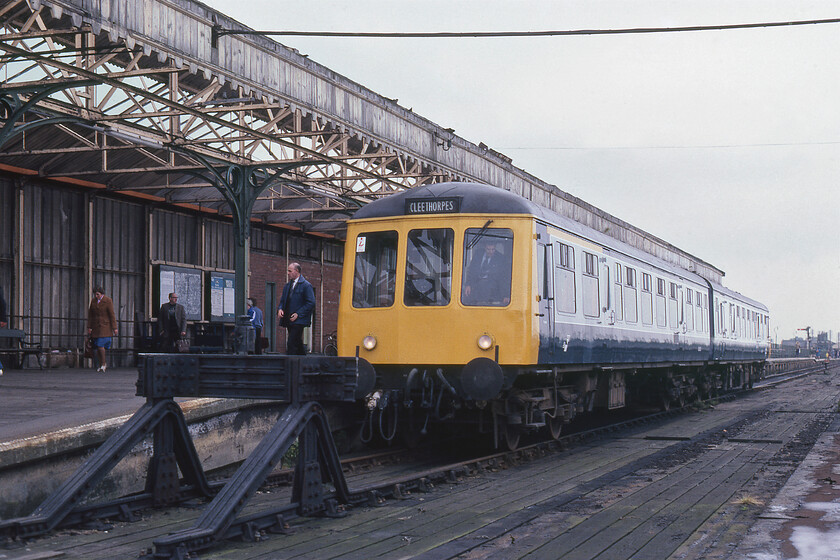 Class 114 DMU, 14.00 Cleethorpes-New Holland Pier, New Holland Pier 
 A Class 116 first-generation DMU has just arrived at New Holland Pier with the 14.00 from Cleethorpes with the crew no preparing it for its return departure. The driver looks as though he is just finishing up in his cab but has yet to switch the tail lights on. Until a few years before this photograph was taken, there were two further tracks at this, the extreme end of the pier. The track to the left provided additional platform capacity with the short centre siding used for the storage of a few coal wagons with the fuel used to fire the various steam ferries that plied the route between here and Hull Corporation pier. Following the withdrawal of the final steam ferry, the MV Lincoln Castle in 1978 (replaced by the diesel-powered MV Farringford) the sidings were removed. 
 Keywords: Class 114 DMU 14.00 Cleethorpes-New Holland Pier New Holland Pier first generation DMU