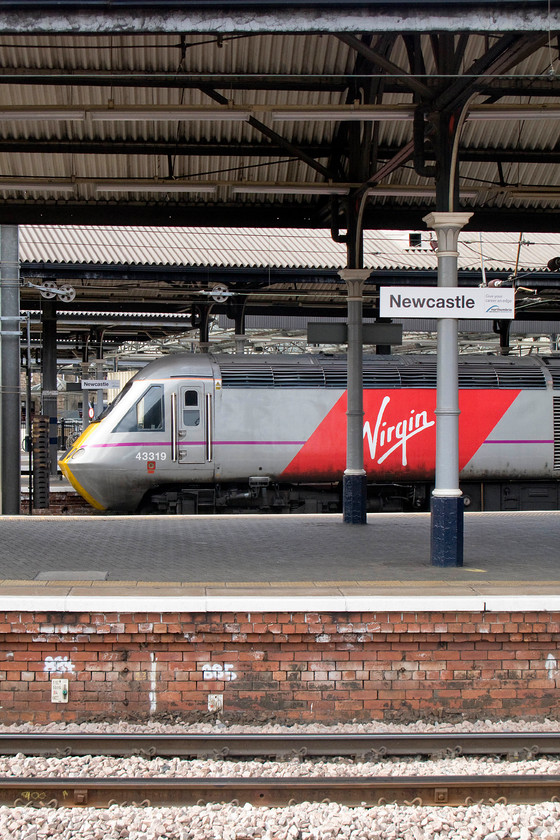 43319, VTEC 12.00 London King`s Cross-Inverness (1S16), Newcastle station 
 No guesses needed as to where this photograph is taken! 43319 is seen at Newcastle station waiting to leave at the rear of the 1S16 12.00 King's Cross to Inverness. The previous operator of services on the ECML, the Department for Transport under the guise of East Coast ceased its operations some weeks ago but Virgin has only made limited progress rebranding the trains. This HST still wears the National Express East Coast (2007-2009) livery as the state-owned and run East Coast operator merely re-branded their stock rather than embarking on a costly re-paint. 
 Keywords: 43319 12.00 London King`s Cross-Inverness 1S16 Newcastle station Virgin East Coast hst