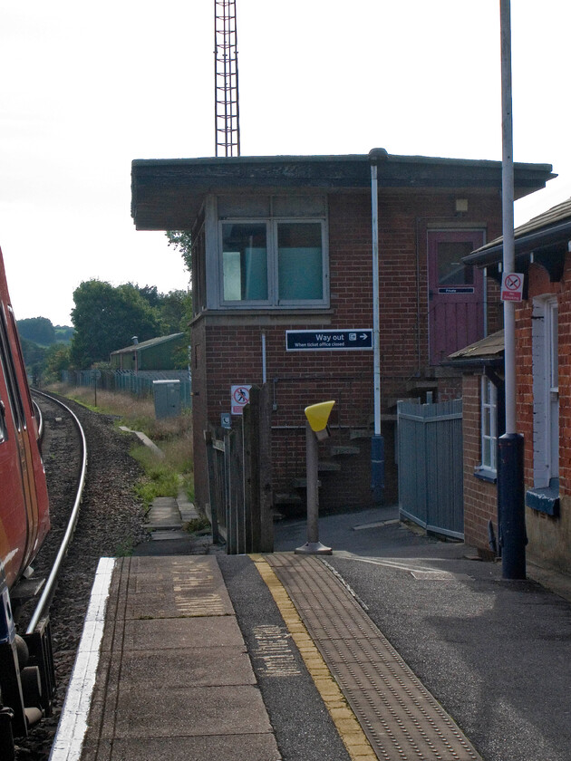 Tisbury signal box (BR, 1958) 
 Taken right into the afternoon sunshine Tisbury signal box is seen from my position jumping on to the platform during our stop at the station. In a typically wasteful manner fitting to British Railways of that era, the box was closed way back in 1967 having only been in operational use for nine years. The closure came about when they made the decision to massively rationalise the route between Wilton Junction (Salisbury) and Exeter with it coming very close to complete closure. Talk today is that it is to be invested in and even re-doubled as traffic increases again. 
 Keywords: Tisbury signal box British Railways 1958