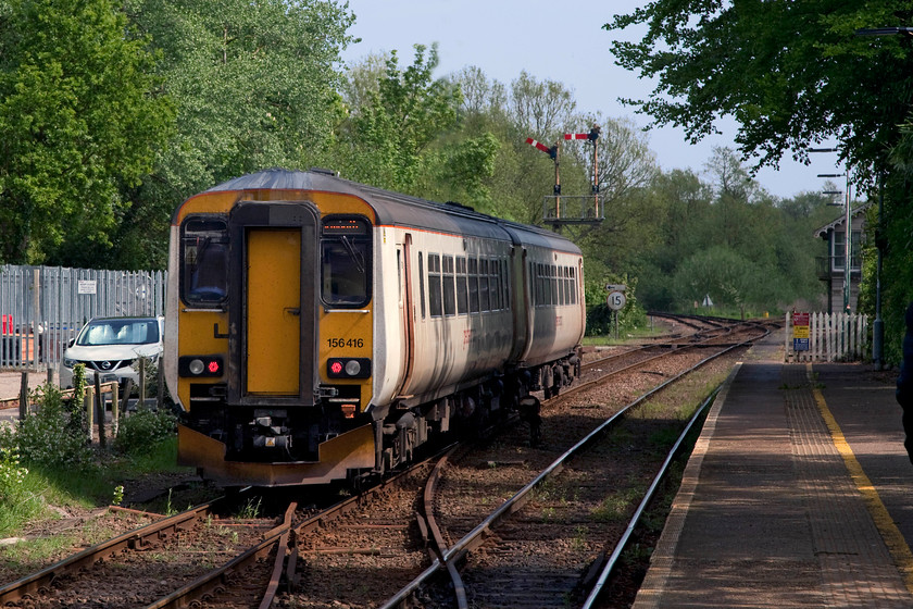 156416, LE 14.40 Norwich-Great Yarmouth (2P24, RT), Brundall station 
 Taken from the up platform at Brundall station 156416 leaves working the 14.40 Norwich to Great Yarmouth. Brundall signal box can just be seen to the right of the picture. The train is signalled to take the Acle line at Brundall Junction. I must admit to some Photoshop 'editing' of this picture. This is not something I do that often, but there was a ghastly telecommunications mast emerging right out out of the middle of the train that I have cloned out. I could also have done with removing the palisade fencing and the white Nissan Qashqui but where do you stop? 
 Keywords: 156416 2P24 Brundall station