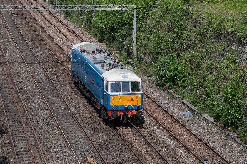 86259, 11.37 London Euston-Rugby Carriage Sidings (0Z88), Hyde Road Bridge 
 This is one of the few occasions when the sun did what it was supposed to do, namely come out at the required moment! Having been a cloudy morning, 86259 'Les Ross/Peter Pan' passes under Hyde Road Bridge in Roade working the 11.37 Euston to Rugby Carriage Sidings (0Z88) light engine move. This is a regular movement for the veteran class 86 after yet another successful railtour that it hauled the previous day. 
 Keywords: 86259 11.37 London Euston-Rugby Carriage Sidings 0Z88 Hyde Road Bridge