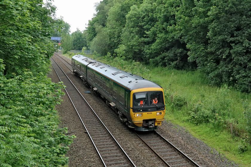 165119, GW 07.25 Banbury-Oxford (2V11, RT), King's Sutton SP494358 
 When I last visited this quiet spot on a rickety accommodation bridge just south of King's Sutton station it was not nearly as overgrown as it is now. A unit fits in the gap afforded by the trees just about okay in fact framing the subject, but anything longer would be more of a challenge. 165119 gets away from the station with GWR's 07.25 Banbury to Oxford all-station stopper service. 
 Keywords: 165119 07.25 Banbury-Oxford 2V11 King's Sutton SP494358 Great Western Railway Turbo GWR