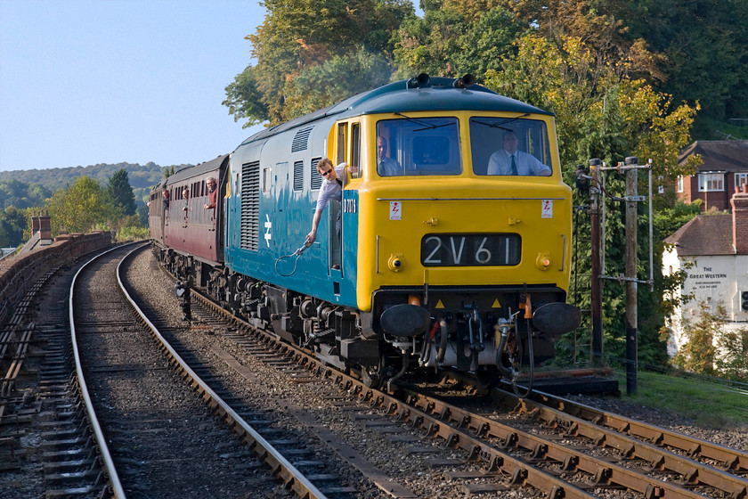 D7076, 14.30 Bridgnorth-Kidderminster, Bewdley station 
 With the 'third-man' leaning out of the door stretching out in readiness to pass the token to the signalman the driver brings D7076 into Bewdley station. The superbly well preserved Class 35 (even though in common with all Hydraulics they never carried a TOPS number) is leading the afternoon 14.30 Bridgnorth to Kidderminster. Notice the appropriately named Great Western pub in the background situated on Kidderminster Road that passes under the railway on an impressive viaduct that the train is currently crossing. 
 Keywords: D7076 14.30 Bridgnorth-Kidderminster Bewdley station Hymek