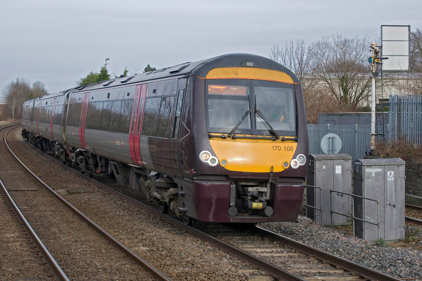 170108, XC 10.22 Birmingham New Street-Cambridge (1L36, RT), Oakham station 
 The 10.22 Birmingham New Street to Cambridge service worked by 170108 arrives at Oakham station catching some welcome, if weak, winter sunshine. Notice the home signal with the arm hidden behind a sighting board to the right that controls the up siding. It appears to see regular use as the rail head was shiny and clean. 
 Keywords: 170108 10.22 Birmingham New Street-Cambridge 1L36 Oakham station Crosscountry