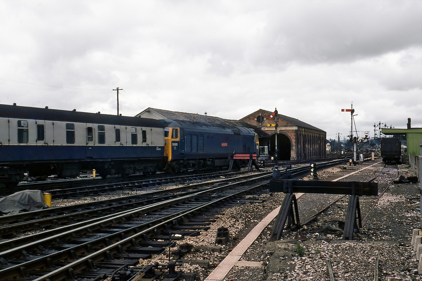 50001, 12.10 Paignton-London Paddington (1A01), Exeter Middle 
 50001 (ex D401) now named 'Dreadnought' leaves Exeter St. David's with the 1A01 12.10Paignton to Paddington service. It was easy to identify particular services at this time as it was policy (on the Western Region at least) to place the reporting number in the windows of the BG, in this case using stick-on labels. Of course, reading these labels when a train was running at speed was all but impossible! In this 'going away' photograph the former goods depot can be seen with an impressive array of mechanical signalling controlled by Exeter Middlel box. Just visible in the distance is Exeter Riverside box and beyond that 47060 is seen approaching with the 10.27 Paddington to Paignton.

There is an audio recording of this event on my youtube channel, see...https://youtu.be/rYJk-LTtHO0 
 Keywords: 50001 12.10 Paignton-London Paddington 1A01 Exeter Middle Dreadnought warship Class 50 47060 10.27 Paddington-Paignton