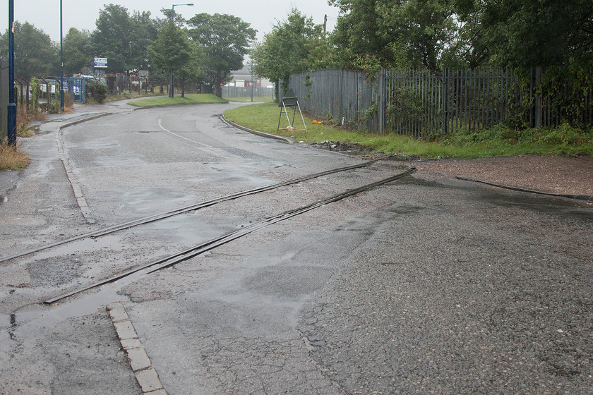 Former siding to Imperial Smelting, Blioxwich SJ994016 
 A reminder of Bloxwich's industrial past is still in evidence on Fryers Road that passes through an industrial estate to the west of the town. This track, laid into the road, led from the mainline behind where I am standing, into a former smelting facility. There appears to be planning to develop the former factory site for housing so I suspect that the tracks will be consigned to history soon. 
 Keywords: Former siding to Imperial Smelting Blioxwich SJ994016