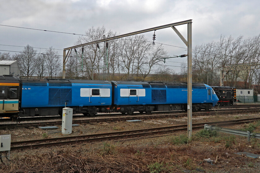 43047 & 43059, stabled, Crewe LSL 
 Arriving at Crewe is now interesting with LSL's extensive and eclectic mix of stock and motive power always on view. Two of its HST reproduction Blue Pullmans poke their noses out from behind a rake of stock. 43047 and 43059 are used on various charters that appear to be highly successful and popular with the charter fraternity; and long may this continue! 
 Keywords: 43047 43059 stabled Crewe LSL Pullman HST Locomotive Services Ltd