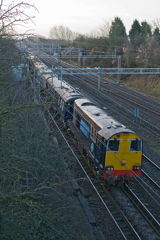 20304, outward leg of The Buffer Puffer 11.1, 05.02 Stafford-London area (1Z57), Victoria bridge 
 Dead in tow on the rear of The Buffer Puffer 11.1 charter 20304 is seen heading south on the WCML just south of Roade. The charter left Stafford running as 1Z57 heading for various unusual tracks and routes withing greater London details of which can be found at http://www.sixbellsjunction.co.uk/ 
 Keywords: 20304 The Buffer Puffer 11.1 05.02 Stafford-London area 1Z57 Victoria bridge Pathfinder Tours DRS Direct Rail Services