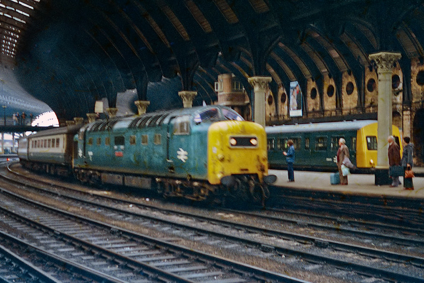 55009, 10.55 London Kings Cross-Edinburgh (1S21) & class 101 DMU, York station 
 A poor quality image taken under York's overall roof showing the 1S21 10.55 King's Cross to Edinburgh entering the station. It is being led by a somewhat faded 55009 'Alycidon' with a class 101 DMU in one of the north-facing bay platforms behind. I attempted to replicate this view in a visit to York station during 2021 see...... https://www.ontheupfast.com/p/21936chg/30013497057/x7-158842-nt-stabled-york-station, no Deltic or Class 101 in the more recent view! 
 Keywords: 55009 10.55 London Kings Cross-Edinburgh 1S21 class 101 DMU York station