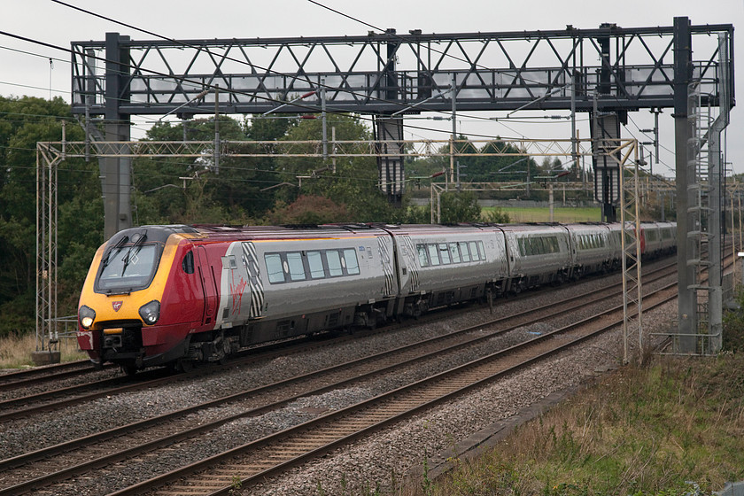 221118 & 221117, VT 08.18 Shrewsbury-London Euston (1B11), Roade Hill 
 Using my tall step ladder to get me above the dreaded palisade fencing at Roade Hill 221118 and 221117 'The Wrekin Giant' pass working the 1B11 08.18 Shrewsbury to Euston. The train will have passed close to the Wrekin (407m), after which the second Voyager is named, just after leaving Shrewsbury. 
 Keywords: 221118 221117 08.18 Shrewsbury-London Euston 1B11 Roade Hill