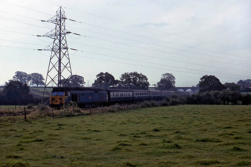 50 022, 06.15 Penzance-London Paddington (1A15), Berkely Down ST793483 
 50022 'Anson' passes Berkely Down on the outskirts of Frome with the 06.15 Penzance to Paddington. I am standing in the interior angle of the mainline that the train is on and the route into Frome that is curving off to the right behind me. 50022 is looking rather works-stained, as many members of the class did at this time prior to their refurbishment. It was the eleventh 50 to enter Doncaster in May 1980 taking seven months before emerging looking somewhat different to how it does here! 
 Keywords: 50 022 06.15 Penzance-London Paddington 1A15 Berkely Down ST793483