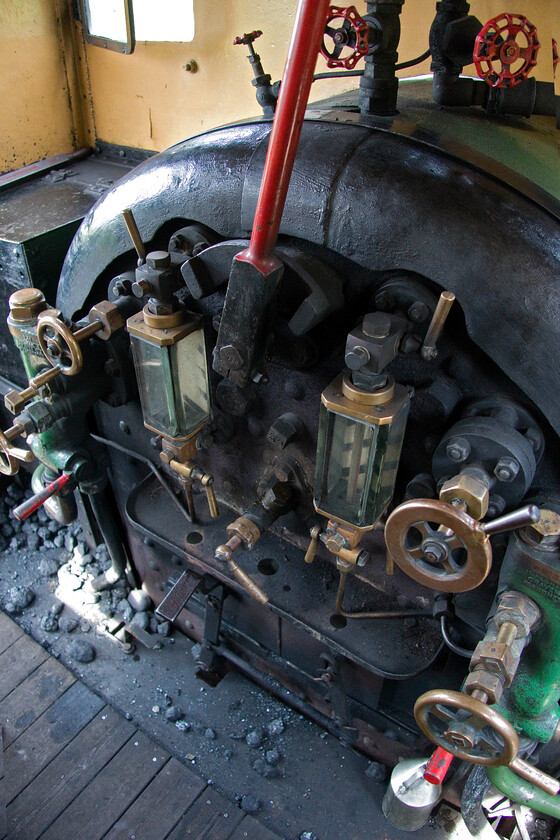 Footplate, No. 4, 12.00 Pitsford return 
 The footplate of number 4 (2104) was fairly compact, to say the least! It would have been tight with just the fireman and driver but the addition of me and my camera made it a little uncomfortable. The controls of the Peckett are extremely simple but will be familiar to any train driver. 
 Keywords: Footplate No. 4 12.00 Pitsford return 2104 Peckett 0-4-0 st