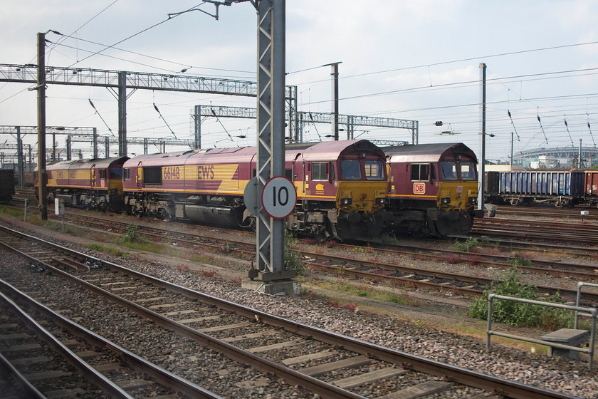 66148 & 66109, stabled, Wembley Yard 
 A trio of class 66s sit stabled in Wembley Yard with the world famous stadium of the same name in the background. To the right is 66109, with 66148 taking centre stage. The 66 to the left is unidentified. 
 Keywords: 66148 66109 Wembley Yard