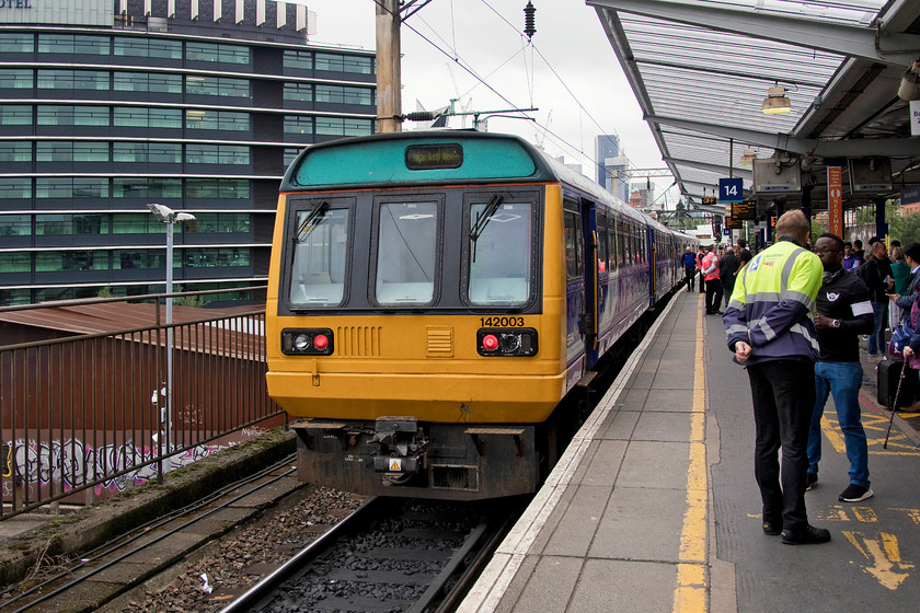 142003, NT 09.18 Manchester Airport-Wigan North Western (2W04, RT), Manchester Piccadilly station 
 A busy scene at Manchester Piccadilly station where I and numerous other travellers were harangued for putting our feet 'over the yellow line'. Admittedly, the station was busier than usual due to the closure of Acton Grange junction and consequential diversions but the number of extra staff drafted in to undertake 'crowd control' was absolutely ridiculous! I do resent being treated like cattle and herded about a station by staff hired in by Network Rail, it just makes me more awkward and forces me to put my foot over the line even more such as when taking this photograph of 142003 leaving Piccadilly with the 09.18 from Manchester Airport to Wigan North Western. 
 Keywords: 142003 09.18 Manchester Airport-Wigan North Western 2W04 Manchester Piccadilly station