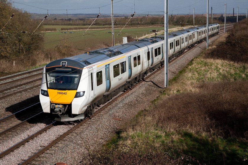 700042, TL 09.24 Bedford-Three Bridges (2W25, RT), Millbrook TL020397 
 700042 forms the 09.04 from Bedford to Three Bridges. It is just a few miles into this journey as it approaches Millbrook. I have yet to travel on one of these 700 units so cannot comment on the issues relating to their hard seating, but they do have quite an act to follow as the 319s that they replaced were (and still are in their new role at Northern Trains) comfortable and competent units. 
 Keywords: 700042 2W25 Millbrook TL020397