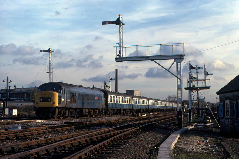 45104, 14.12 London St. Pancras-Derby, Cricklewood yard 
 Still wearing its nameplates, 45104 'The Royal Warwickshire Fusilier' leads the 14.12 St. Pancras to Derby past Cricklewood. The train is composed of a long rake of somewhat faded Mk. 1 stock. The sea of semaphores that the train is passing is a reminder of another era in our railway heritage. These particular ones had a very limited time left as the MML resignalling programme was well under way even though there is little evidence in this photograph. 
 Keywords: 45104 14.12 London St. Pancras-Derby Cricklewood yard