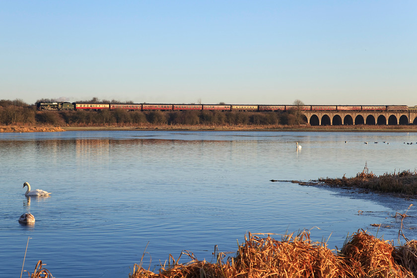 46100, outward leg of The York Yuletide Express, 06.55 Ealing Broadway-York (1Z44), Nene Valley SP913670 
 Just a whisper of wind has spoilt the formation of a reflection of 46110 'Royal Scot' and its train in the former gravel pit lake down in the Nene Valley near Wellingborough. The 4-6-0 is hauling the outward leg of The York Yuletide Express from Ealing Broadway to York. So, not only was there an absence of condensing exhaust on show but no lovely reflection, some of the best made plans and all that! 
 Keywords: 46100 The York Yuletide Express 06.55 Ealing Broadway-York 1Z44 Nene Valley SP913670