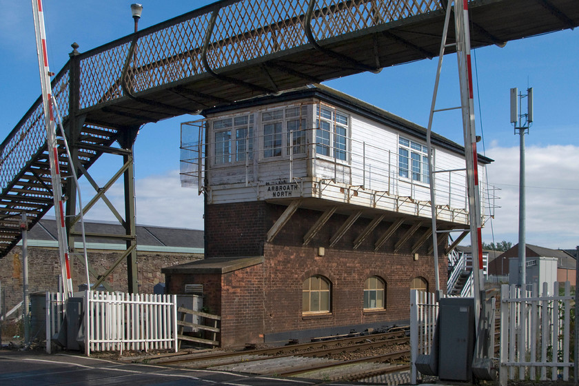 Arbroath (North) signal box (NB, 1911) 
 The absolutely superb North British Arbroath North signal box dating from 1911 sits in the late afternoon sunshine. Whilst Railtrack undertook some remedial modernisation work in the early 2000s the box is largely original save for replacement windows to the cabin. It still retains its dog-leg wooden steps, chimney stack, hipped slate roof and three over three glazed windows to the frame room. When combined with the cast-iron latticed footbridge it makes for a superb scene. It's just a shame that the telecoms mast and electric barriers spoil things! Incidentally, there is no longer a South box (closed in 1971), or any other for that matter, in the Arbroath area it's just that the North box has never lost its old name adding to the historical interest. 
 Keywords: Arbroath North signal box North British