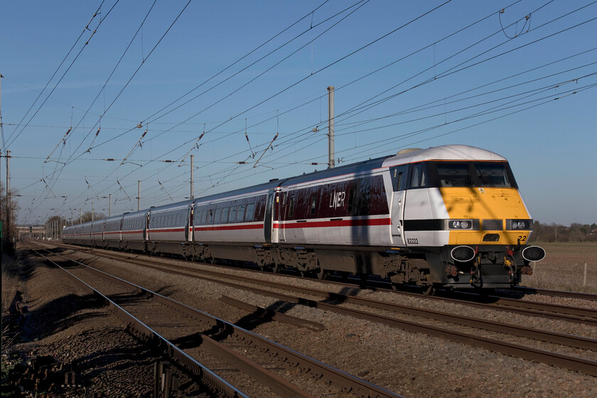 82222, GR 12.02 York-London King's Cross (1Y84, 29L), Holme Green crossing TL192426 
 With the sun getting lower in the clear winter sky the shadows are lengthening in this view at Holme Green occupation crossing a short distance south of Biggleswade. In these superb afternoon conditions, DVT 82222 leads LNER's 12.02 York to King's Cross stopper. Now very much in their twilight years the few remaining IC225 sets can be found on these services (and those to and from Leeds) very much in the same way that the Deltics spent their final time on the ECML in the early 1980s. 
 Keywords: 82222 12.02 York-London King's Cross 1Y84 Holme Green crossing TL192426 LNER IC225 DVT