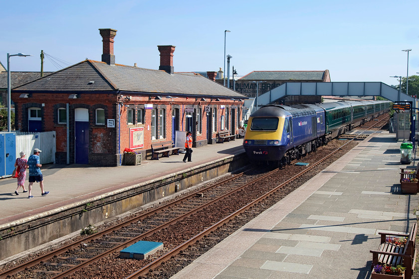 43020, GW 10.20 Penzance-London Paddington (1A83, 24L), Camborne station 
 The dispatcher watches 43020 'MTU Power, Passion, Partnership' bring up the rear of the 10.20 Penzance to Paddington 1A38 service as it leaves Camborne station. This train shows the typical pick and mix arrangement of the HSTs whereby a repainted green set of stock has a older liveried FGW power car spoiling the effect. However, from a photographic point of view, I prefer the indigo neon blue colour of the power car to the green of the stock. 
 Keywords: 43020 1A83 Camborne station