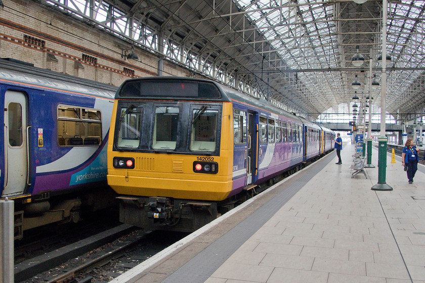 142052, NT 09.09 Manchester Piccadilly-Rose Hill (2R05, RT), Manchester Piccadilly station 
 142052 and another unit leave Manchester Piccadilly with the 09.09 to Rose Hill. In theory, and to comply with the law, these units should be withdrawn from service within six months. However, Northern has recently announced that this deadline is not going to be met leaving them in a tricky situation, a mass cancellation of services (sounds familiar?) or continue with some still in service and break the law. 
 Keywords: 142052 09.09 Manchester Piccadilly-Rose Hill 2R05 Manchester Piccadilly station