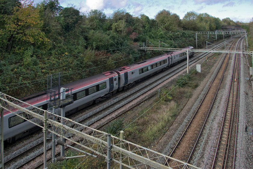 221106, stopped, dead train ex Milton Keynes Central (1Z77), A508 bridge 
 All is not what it seems in this photograph. It is not a particularly poor going-away image of a Voyager passing through Roade but one showing 221106 stationary due to downed catenary just in front of it. I am not at all sure if it was a service train or an ECS sent to inspect the line. I say this as I observed it both on Open Train Times and just across the field from home moving at a walking pace until forced to sop here in Roade seen from the A508 bridge. 
 Keywords: 221106 stopped dead train ex Milton Keynes Central 1Z77 A508 bridge Voyager Avant West Coast