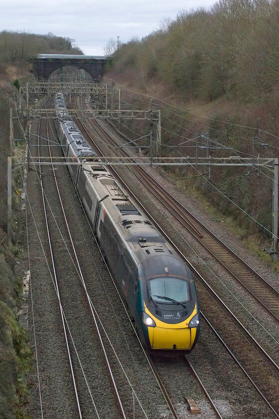 390137, VT 11.55 Manchester Piccadilly-London Euston (1A09, 3E), Hyde Road bridge 
 To end the year another strike-riven day was affecting all Avanti services. With the driver's pay deal settled earlier in the year, this dispute involved guards (train managers in modern parlance) and rest day working pay parity with managers. AWC were running a basic service with hourly services to and from London between their principle stations. One of these services, the 11.55 Manchester to Euston passes through Roade cutting worked by 390137. 
 Keywords: 390137 11.55 Manchester Piccadilly-London Euston 1A09 Hyde Road bridge AWC Avanti West Coast Pendolino