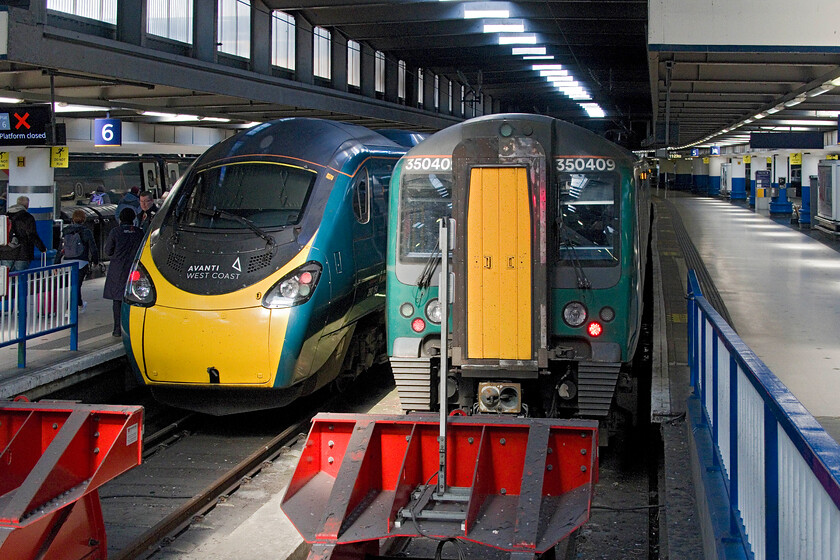 350409, LN 09.06 Birmingham New Street-London Euston (1V26, 2L) & 390154, VT 07.00 Lancaster-London Euston (9A31, 8L), London Euston station 
 Having arrived at Euston station I turned my camera around to capture the train that we had travelled from Northampton. 350409 was paired with 350114 working the 09.06 London Northwestern service from Birmingham New Street. To its left 390154 rests after arriving with the 07.00 AWC service from Lancaster. 390154 is one of a handful of Pendolinos that is not and has never carried a name or has been selected as one of those to carry any special promotional vinyls. 
 Keywords: 350409 09.06 Birmingham New Street-London Euston 1V26 390154 07.00 Lancaster-London Euston 9A31 London Euston station London Northwestern Desiro AWC Avanti West Coast Pendolino