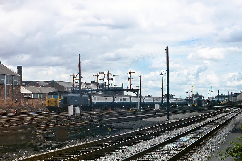 50043, 10.55 London Paddington-Paignton (1B62), Taunton West 
 This classic location, to the west of Taunton station at the foot of Forty Steps Bridge, sees 50043 'Eagle' leaving the station with the 1B62 10.55 London Paddington to Paignton. Taunton was this trains second stop of its journey after Reading. The magnificent gantry seen here was wiped away, along with all the other mechanical signaling, when the Exeter PSB was activated in 1986. The track layout at this end of Taunton station is hugely simplified today with a fraction of what is seen here still in existence. 
 Keywords: 50043 10.55 London Paddington-Paignton 1B62 Taunton West