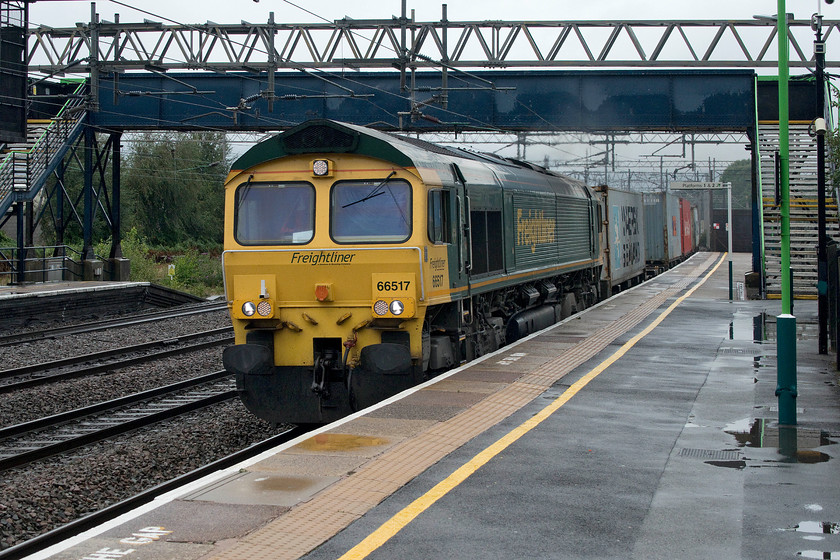 66517, 14.03 Ditton- Felixstowe North (4L92), Rugeley Trent valley station 
 With the rain starting again, 66517 passes at speed through Rugeley Trent Valley station leading the 14.03 Ditton to Felixstowe Freightliner service. This was not the ideal position to capture this train but it was moving too quickly for Andy and me to get ourselves to a better spot on the station. 
 Keywords: 66517 14.03 Ditton- Felixstowe North 4L92 Rugeley Trent valley station