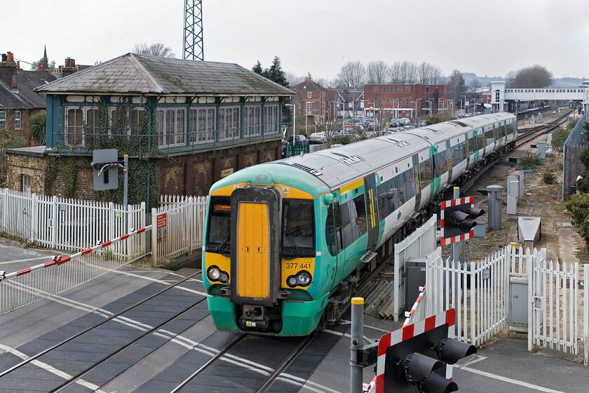 377441, SN 13.13 Southampton Central-London Victoria, New Lane Crossing, Havant 
 Electrostar 377441 leaves Havant station working the 13.13 Southampton Central to London Victoria service. The photgraph is taken from the pedestrian footbridge that permits people to continue along New Lane when the barriers are lowered; something that happens a lot with this section of line being busy. Notice the disused LBSC signal box dating from c.1876 behind the train. 
 Keywords: 377441 13.13 Southampton Central-London Victoria New Lane Crossing Havant Southern Electrostar