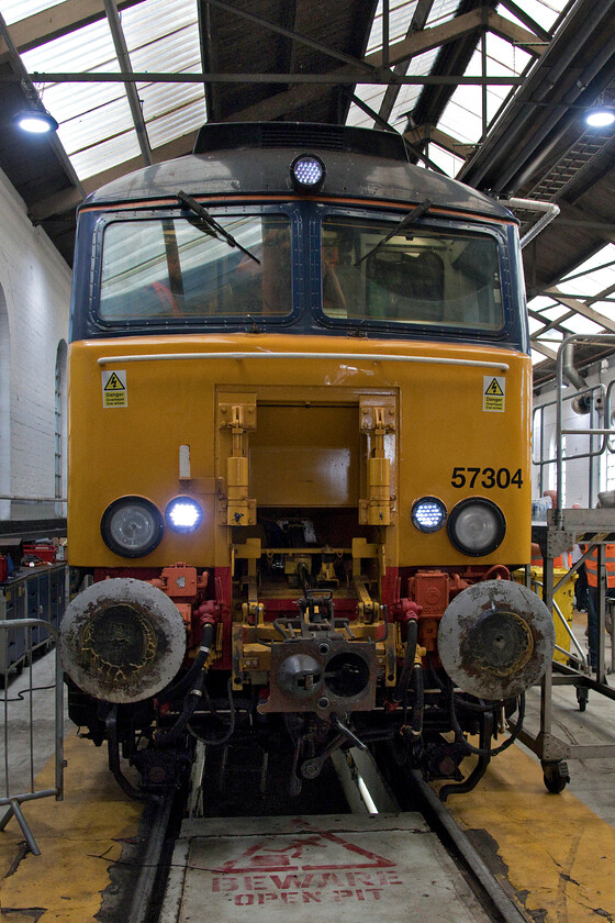 57304, on display Crewe Gresty Bridge 
 In this view, taken inside the former GWR wagon repair shed at Gresty Bridge, there appear to be very few visitors about attending the DRS open day. However, looks can be deceiving as I must have just managed to press the shutter at the right time! 57304 'Pride of Cheshire' was on display and open for visitors to climb into the cab, indeed close inspection reveals some people inside. Prior to it's life with DRS 57304 was one of Virgin's Thunderbirds named 'Gordon Tracy', under TOPS it was numbered 47055 (later 47652 and 47807) and a regular performer throughout the West Country during my early spotting days, for example, seen near Taunton in 1980, see.... https://www.ontheupfast.com/p/21936chg/29441745804/x47055-10-27-london-paddington-paignton 
 Keywords: 57304 on display Crewe Gresty Bridge Pride of Cheshire