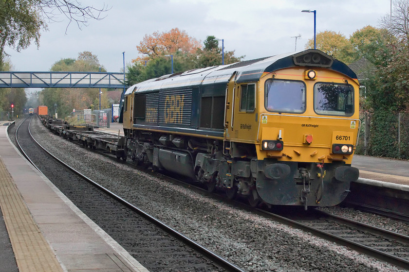 66701, 13.22 Hams Hall-Southampton Western Docks (4O69), Lapworth station 
 66701 speeds southwards through Lapworth station with the lightly loaded 13.22 Hams Hall to Southampton Western Docks Freightliner. There are some lovely colours in the trees meaning that it can only be autumn that helps create some nice images, but, a bit more sun would have helped in this particular case! 
 Keywords: 66701 13.22 Hams Hall-Southampton Western Docks 4O69 Lapworth station