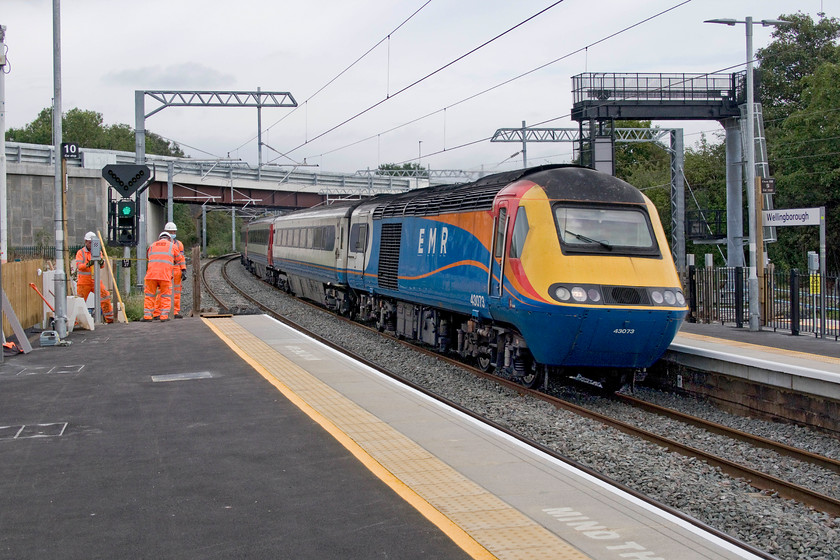 43073, EM 06.34 Leeds-London St. Pancras (1B23, RT), Wellingborough station 
 43073 leads the 06.34 Leeds to St. Pancras East Midlands Railway HST service through Wellingborough station. Work continues to finish the virtual complete re-build of the station, bar the actual buildings themselves, with the new requisite barriers being installed at the top of the platform ramps. 
 Keywords: 43073 06.34 Leeds-London St. Pancras 1B23 Wellingborough station EMR East Midlands Railway HST