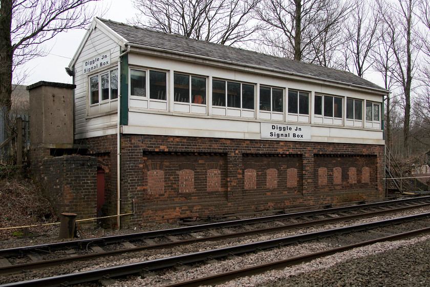 Diggle Junction signal box (LNW, 1885) 
 Diggle Junction signal box is a large box constructed by the London and North Western Railway in 1885. It used to control an extensive area of yards and Diggle station, a short distance to the east of the box. It was named Junction as it used to be where the former Micklehurst loop diverged that ran along the other side of the Tame Valley to Stalybridge thus duplicating the Mossley route. This loop was used mainly for freight utilising the now closed single bore Standedge tunnels, colloquially referred to as the Nicholson and Nelson bores. The signal box has now been hugely rationalised, with only the section at this end being in use. It has also been clad in plastic and had its windows replaced by UPVC units. It does still retain some its L&NW character through. 
 Keywords: Diggle Junction signal box