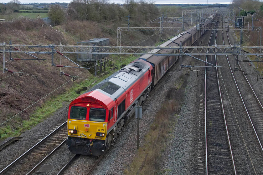 66102, 06.53 Dollands Moor-DIRFT (6M45, 23E), Victoria bridge 
 This is my first photograph of 66102 in several years and definitely my first since it received its smart new DB paint scheme. Brightening up the drab and grey late December weather it leads the 06.53 Dollands Moor to Daventry (DIRFT)' water train' past Victoria bridge just south of Roade. 
 Keywords: 66102 06.53 Dollands Moor-DIRFT 6M45 Victoria bridge DB Water Train