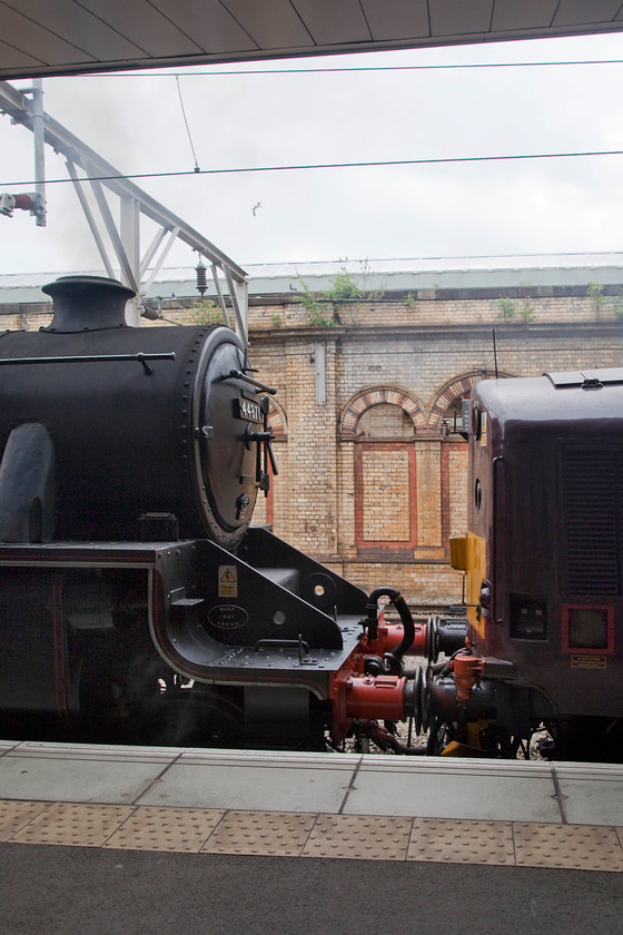 44781 & 37706, taking water, Crewe station 
 Locomotive front end design that is only separated by 14 years! Stanier 44781 was released into traffic in 1947 with 37706 as D6716 (later to become 37016) in 1961. Here, the two locomotives are seen at Crewe platform 12 waiting to continue their journey from Carnforth to Bristol after 44781 had taken water. 
 Keywords: 44781 37706 Crewe station