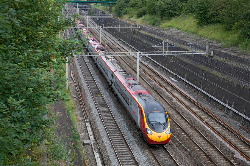 390157, VT 08.05 Manchester Piccadilly-London Euston (1A02), Roade cutting 
 390157 (the last of the class) 'Chad Varah' passes through Roade cutting with Virgin's 1A02 the 08.05 Manchester to Euston service. This is the first up Manchester express on a Sunday getting passengers to the capital in just about two hours. 
 Keywords: 390157 08.05 Manchester Piccadilly-London Euston 1A02 Roade cutting Virgin West Coast Pendolino Chad Varah