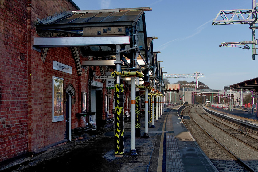 Platform 1, Wellingborough station 
 Wellingborough station is grade two listed as a superb example of a delightful ex Midland Railway structure. So, I am extremely concerned and somewhat surprised at the brutal approach taken by Network Rail to cut back the canopies in exactly the same way that Kettering station was butchered in the 1970s. I sincerely hope that the canopies are to be refurbished and the extensions that have been removed will be reinstated as, in this state, they look woefully imbalanced and out of proportion with the building.

I am pleased to say that by the winter of 2021 that the canopies have been reinstated and now just require the glazing to be reinstalled, see...... https://www.ontheupfast.com/p/21936chg/30022597122/x4-reinstated-canopy-wellingborough 
 Keywords: Platform 1 Wellingborough station