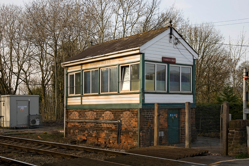 Furness Vale signal box (LNWR, 1897) 
 The classic looking 1897 LNWR type 4 Furness Vale signal box sits in the early evening sun adjacent to the level crossing and station, both to my right. Whilst the box has had the uPVC treatment, it retains its character complete with a pair of fine finials and the BR (LMR) flanged enamel nameplate. Unfortunately, it has lost its chimney and I can find no photographs of the box with it still extant. 
 Keywords: Furness Vale signal box