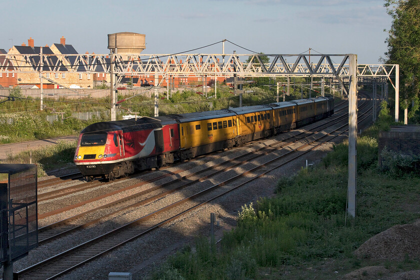 43290 & 43274, 14.28 Derby RTC-Derby RTC (via Euston), (1Q28, 16E), site of Roade station 
 Tuesday is the usual turn of the WCML to have the Network Rail testing train. Having missed the up working earlier in the afternoon I made a point to capture the return working. With two former LNER power cars working the train it is seen passing Roade in some superb evening lighting. 43290 leads the 1Q28 14.28 Derby RTC return working with 43274 at the rear. The rear power car gained celebrity status in 2021 being the only HST power car that was painted in EMR's house purple livery all to great fanfare, see..... https://www.youtube.com/watch?v=UxSKQD-kjyY It retains this de-branded livery today now seeing use with Network Rail but creating an unfortunate colour clash with their house yellow paint scheme as applied to the stock! 
 Keywords: 43290 43274 14.28 Derby RTC-Derby RTC via Euston 1Q28 site of Roade station