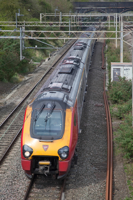 Class 221, VT 12.30 Birmingham New Street-London Euston (1B44, RT), site of Roade station 
 A Virgin class 221 passes the site of Roade station working the 12.30 Birmingham New Street to London Euston. It's a pretty poor show when a service such as this, completely under the wires, has to be formed of a diesel unit. It goes to show how pushed the the TOCs are when it comes to the use of their limited resources. 
 Keywords: Class 221 1B44 site of Roade station