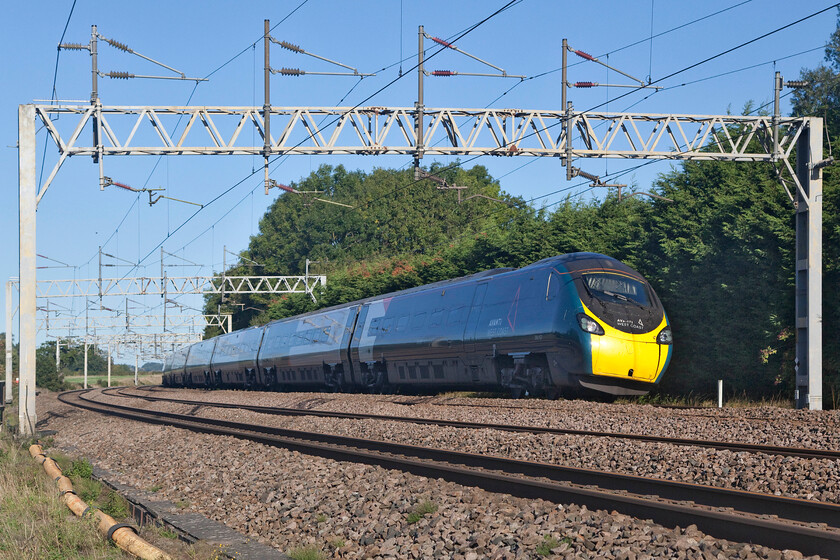 390157, VT 06.30 Glasgow Central-London Euston (1Z07, 3L), Heamies bridge 
 The last of the set, 390157 'Chad Varah' sweeps around the deeply cambered (or canted to use correct railway parlance) on the approach to Norton Bridge Junction working the 06.30 Glasgow Central to Euston Avanti service. It is unfortunate that the strong early morning sunshine has not come around far enough to illuminate this side of the train but I really like the perspective and the framing of the image that conveys what a Pendolino does best! 
 Keywords: 390157 06.30 Glasgow Central-London Euston 1Z07 Heamies bridge Avanti West Coast Pendolino Chad Varah