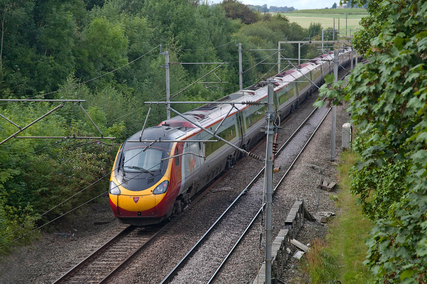 390132, VT 14.03 London Euston-Birmingham New Street (9G25, RT), Dodford Lane Bridge SP623607 
 390132 'City of Birmingham' heads north working the 14.03 Euston to Birmingham New Street. The train is seen from the Dodford Road bridge that links the village of the same name to the A5. Unfortunately, the whole line in this really is difficult to access and is somewhat overgrown so the pictures are 'fussy' with the electrification paraphernalia often in the way. 
 Keywords: 390132 9G25 Dodford Lane Bridge SP623607