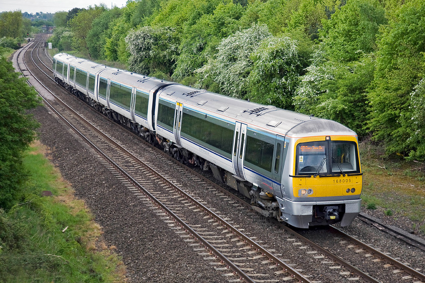 168005, CH 08.27 London Marylebone-Birmingham Snow Hill (1G12), Hardwick Farm bridge SP463429 
 Chiltern's 168005 climbs away from Banbury forming the 08.27 Marylebone to Birmingham Snow Hill service. Whilst the scene appears bucolic with the intense greens of spring providing the backdrop, looks can be deceiving with the busy M40 behind me providing a constant and intrusive soundtrack. 
 Keywords: 168005 08.27 London Marylebone-Birmingham Snow Hill 1G12 Hardwick Farm bridge SP463429 Turbo Chiltern Railways