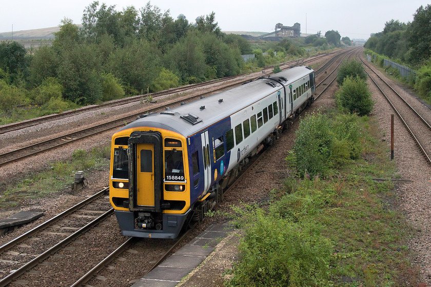 158849, NT 14.02 Scarborough-Sheffield (1J13, 2L), Hatfield & Stainforth station 
 Looking very smart in the new Northern livery 1588849 passes through Hatfield and Stainforth station forming the 14.02 Scarborough to Sheffield service. The train has just passed the former Hatfield colliery that finally closed in 2015 bringing to an end one hundred and five years of production. The point in the distance where the tracks go out of sight is where the infamous slip occurred during 2013 when a spoil heap, loosened by rain soaking into it, of an estimated 1,000,000 cubic meters slumped on to and completely overwhelmed the running lines. It took until July to clear the lines and stabalise the land, a major headache for train planners as the four tracks seen are strategically important, particularly to freight movement. 
 Keywords: 158849 14.02 Scarborough-Sheffield 1J13 Hatfield & Stainforth station