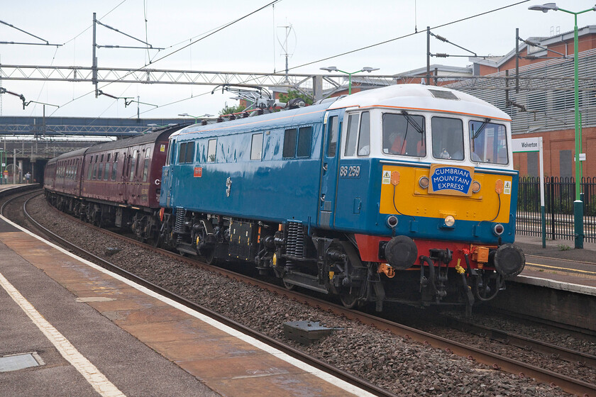 86259, outward leg of The Cumbrian Mountain Express, 07.08 London Euston-Carlisle (1C96, 26L), Wolverton station 
 86259 'Les Ross/Peter Pan' passes through Wolverton station leading the outward leg of The Cumbrian Mountain Express. It was to lead the train that, in a break from tradition, was running as 1C96 rather than its more usual 1Z86, as far Carnforth where 46115 'Scots Guardsman' would take over. However, something went wrong with the train leaving some forty-three minutes late. I am not sure if this was a problem with the Royal Scot - advice anybody? Usually, the regular passage of 86259 on a Cumbrian Mountain/Coast Express attracts little interest from enthusiasts but on this occasion, there were a number of photographers on Wolverton station eager to capture the scene. 
 Keywords: 86259 The Cumbrian Mountain Express 07.08 London Euston-Carlisle 1C96 Wolverton station AL6 Les Ross Peter Pan